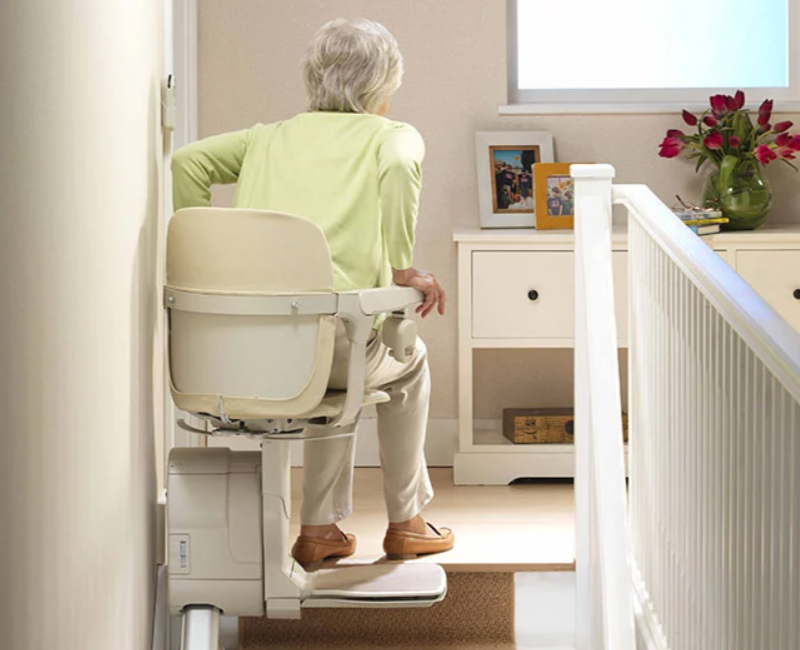 Elderly Woman Getting Up Off of a Stannah Stair Lifts in Rochester, Buffalo, Erie, and Ithaca, NY