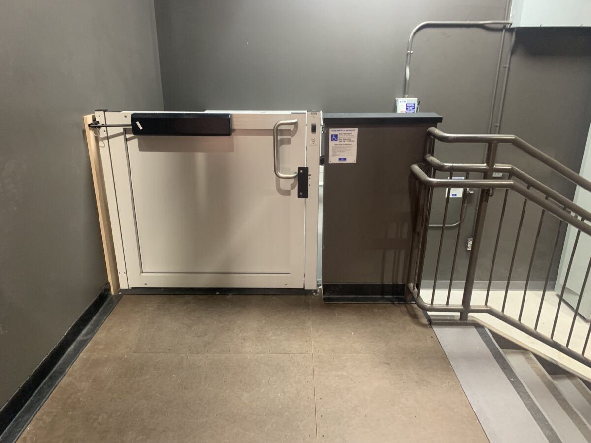 Commercial installation of a unenclosed wheelchair lift at the top landing